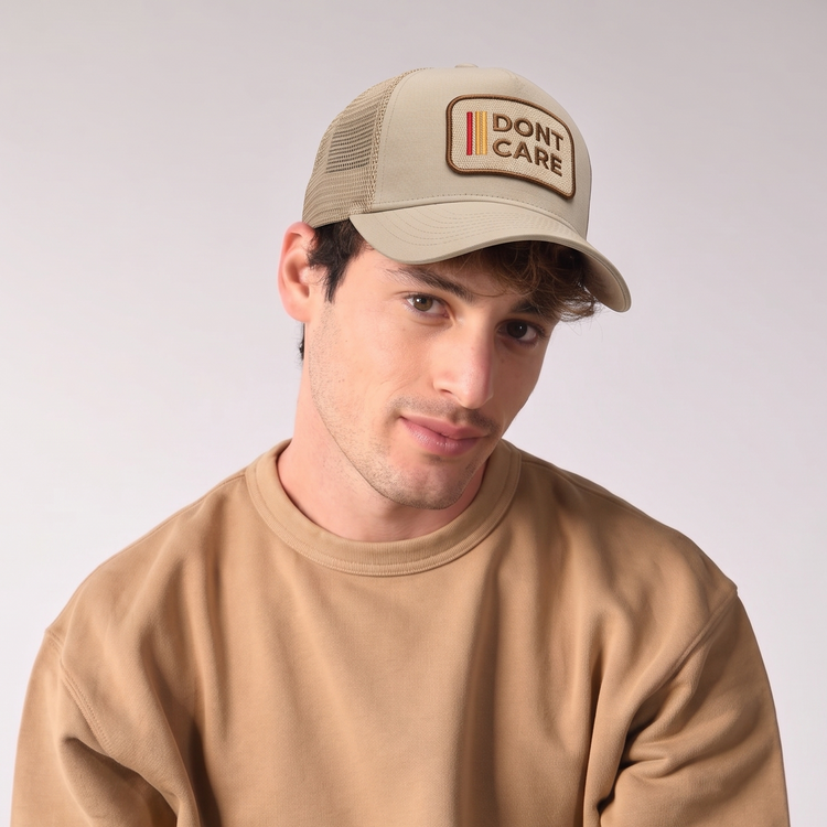 Don't Care Trucker Cap by Sand and Camels - model wearing the cap